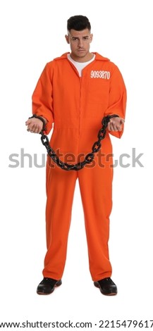 Prisoner in orange jumpsuit with chained hands on white background Royalty-Free Stock Photo #2215479617