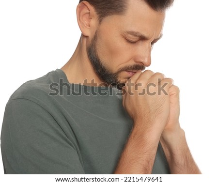 Man with clasped hands praying on white background, closeup