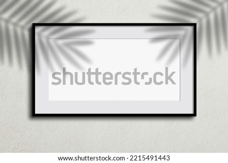 White blank frame with tropical tree leaf shadows on the wall background