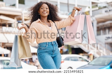 Shopping, fashion and retail, a black woman with smile and designer boutique shopping bags outside a mall. Happy customer or influencer after discount sale in city shopping mall parking lot or street Royalty-Free Stock Photo #2215495821