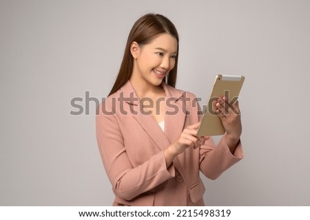 A Young asian woman using tablet over white background, technology concept. 	