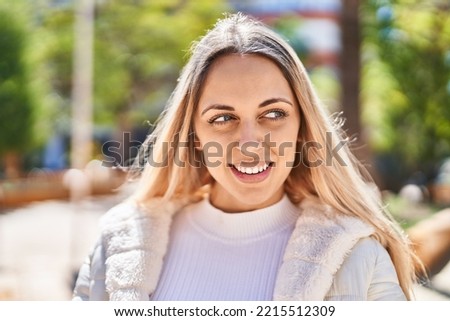 Young woman smiling confident standing at park