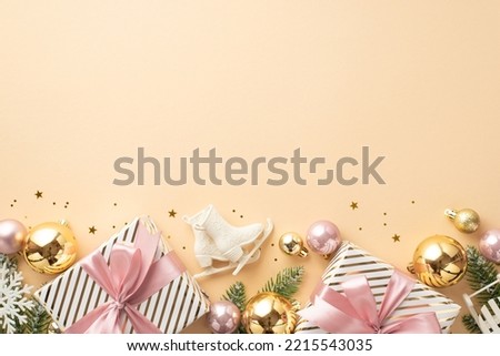 New Year concept. Top view photo of gift boxes with bows gold and pink baubles ice skates snowflake ornaments pine branches in snow and confetti on isolated pastel beige background with empty space