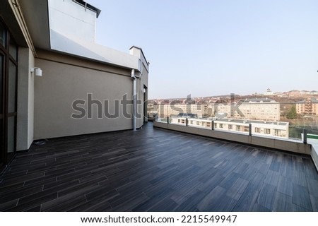 a large clean balcony in an apartment in a high-rise building