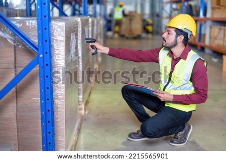ware house worker stock check and barcode scan the goods on wooden pallet wrapped with plastic sheet