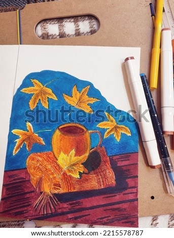 Drawing of a cup of coffee in autumn hygge style with yellow leaves and a woolen plaid. Photo with felt-tip pens and a drawing tablet, top view