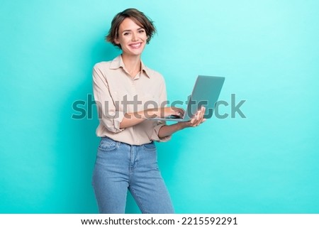 Photo of young charming attractive businesswoman using her laptop count financial profit good mood positive isolated on aquamarine color background