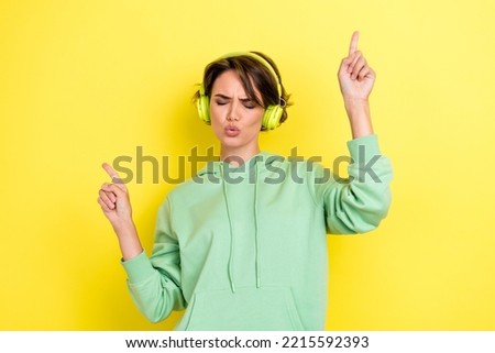 Photo of cheerful optimistic satisfied girl with bob hairstyle wear green hoodie dancing enjoy music isolated on yellow color background Royalty-Free Stock Photo #2215592393
