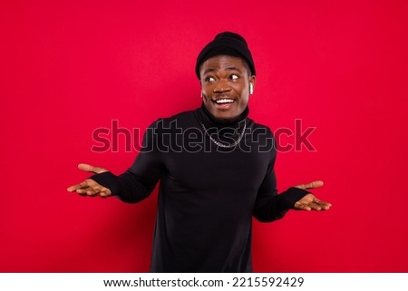 Photo of funny unsure young guy wear black turtleneck headwear listening music looking empty space isolated red color background