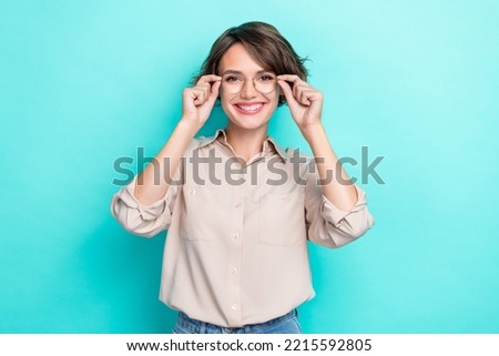 Photo of good mood gorgeous girlish woman with bob hairdo dressed beige blouse hands hold glasses isolated on teal color background Royalty-Free Stock Photo #2215592805