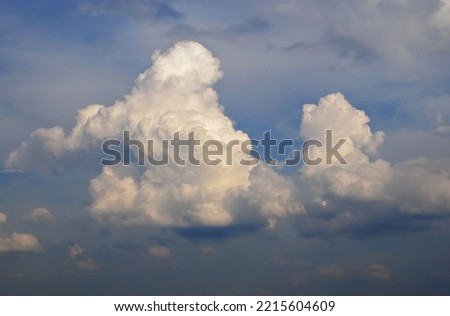Sunset on blue sky. Blue sky with some clouds. blue sky clouds, summer skies, cloudy blue sky background. Aerial sunset view. Evening skies with dramatic clouds. View over the clouds.