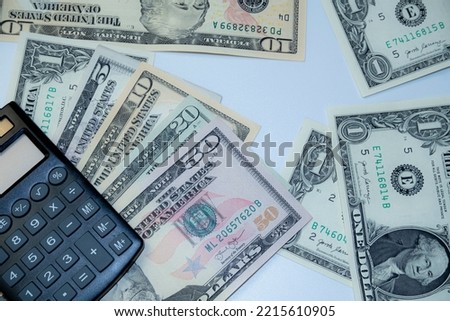 Canculator on the photo of money. calculate the cost of a car trip