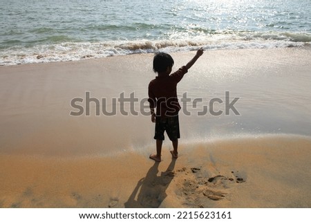 Little boy playing on a beach