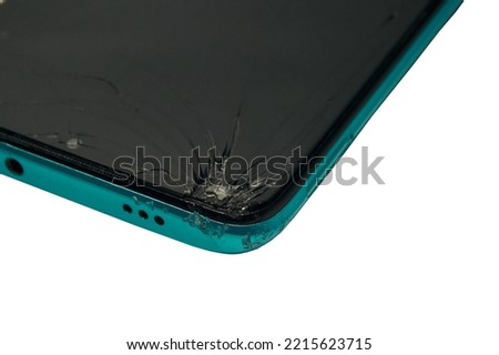 Damaged cell phone screen after a fall, missing a part of the smartphone screen glass, close-up