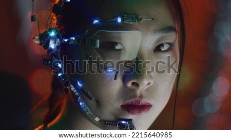 A Cyberpunk girl wearing a headset with microphone, one-eye glasses and white small LED lights. Red neon lights in the background. Asian girl in cyberpunk attire. Cyber and sci-fi backgrounds.