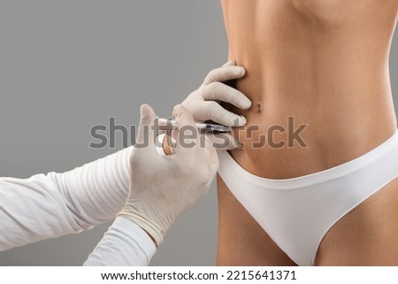 Fat Dissolving Injections. Unrecognizable Doctor Making Lipolysis Shot With Syringe To Female Belly, Young Female In Underwear Getting Slimming Treatment By Professional Beautician, Cropped