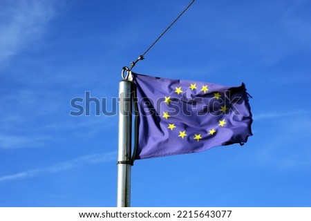 European union flag flies at the bow of a ship in the wind