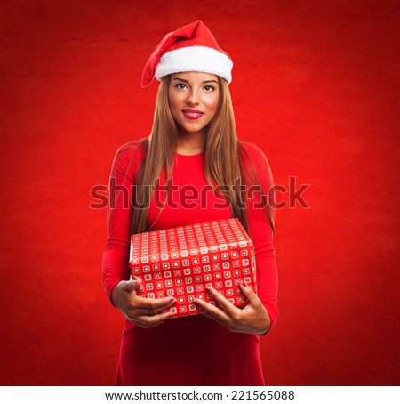 portrait of a beautiful young woman holding a gift box at Christmas