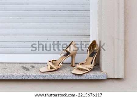 Used, old, beige women's shoes placed on a window sill for take away, Berlin-Friedrichshain, Germany Royalty-Free Stock Photo #2215676117