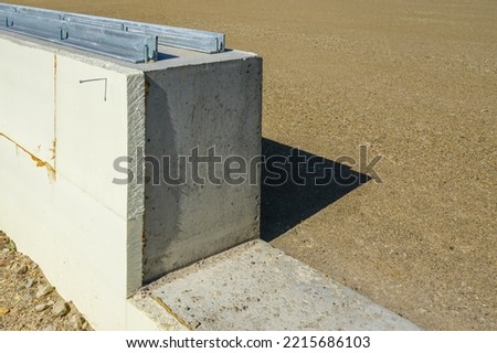 prepared base and concrete border for installation of inflatable playing arena, football hall, air dome on blue sky background Royalty-Free Stock Photo #2215686103