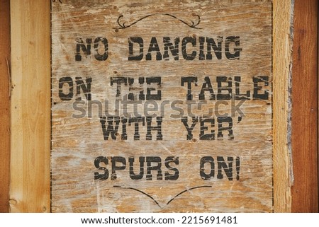 Old wooden tablet in a wild west saloon