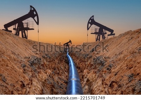 Natural gas pipeline and Crude oil pump jack at oilfield.  Petrochemical Pipe with crude oil and natural gas. Natural gas pipeline for transport gas to LNG plant. Oil drill rig and drilling derrick
