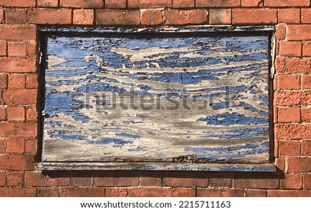 A Smashed Window Boarded up with An Old Blue Wooden Board