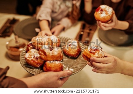 Close up of cozy family with children enjoying homemade pastry at dinner table