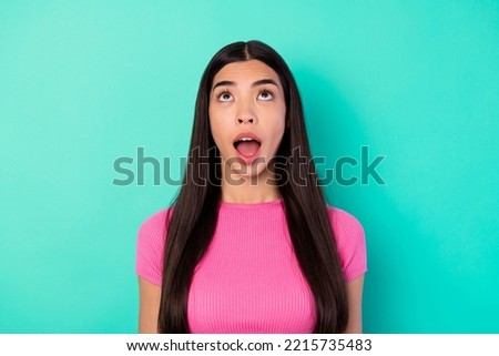 Photo of charming impressed crazy girl see shopping promotion poster above her isolated on turquoise color background