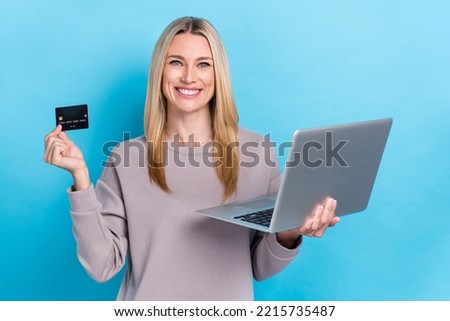 Photo of adorable lady bank client satisfied functions plastic card rejoice online shopping eshop service isolated on blue color background