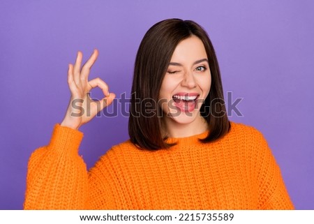 Photo of positive pretty person eye wink arm demonstrate okey symbol isolated on violet color background