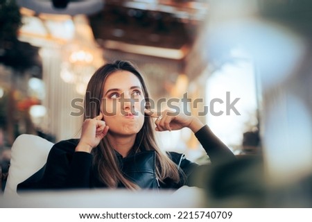 
Stressed Woman Covering her Ears in a Restaurant. Unhappy person bothered by the environmental nose trying to ignore it
 Royalty-Free Stock Photo #2215740709