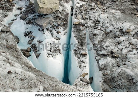 The crevice of a glacier in Alaska.  Geography not found in the lower states of the US. In July, there is active melting causing the deep cracks and changing terrain.
