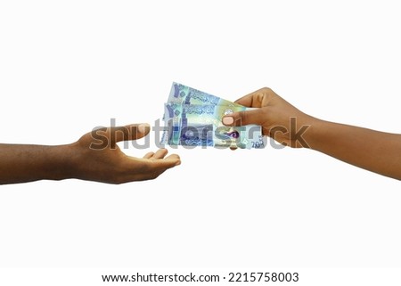 Hand giving 3D rendered Kuwaiti dinar notes to another hand. Hand receiving money Royalty-Free Stock Photo #2215758003