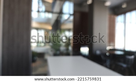 Blur of modern office with open space to work thought the window and background city.