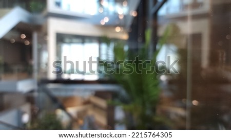 office building lobby blur background interior view toward reception hall, modern luxury main stair space with blurry corridor and building glass wall window.