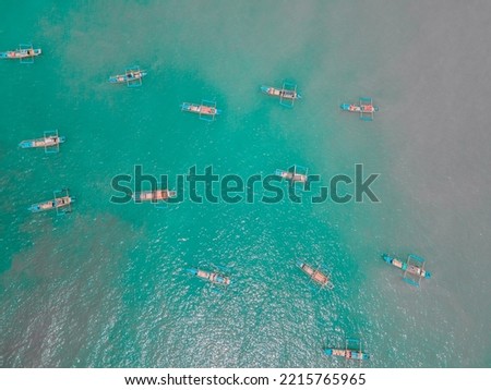 BANTEN, INDONESIA - JULY 10th, 2022 : View of a group of fishing boats during the day seen from above the drone. Photo taken using a DJI drone.