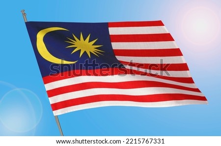 Waving national flag of Malaysia on blue sky