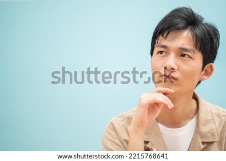 A young Japanese man wearing a jacket Royalty-Free Stock Photo #2215768641