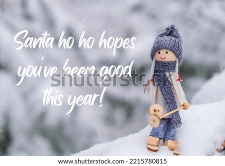 Santa ho ho hopes you have been good this year Inspiration joke quote phrase Angel gnome in scarf and knitted hat skiing on snowy fir branch Elf toy on skis in snowy landscape New year and Merry