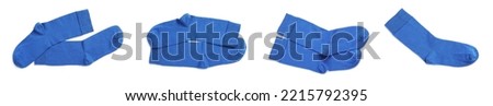 Set with pairs of blue socks on white background, top view. Banner design