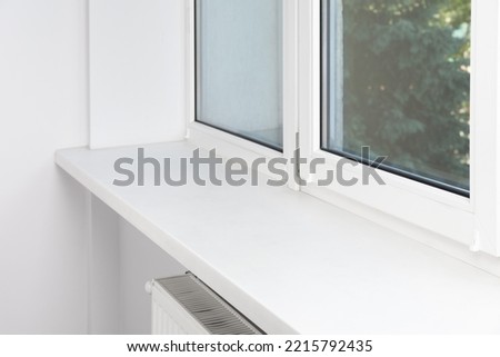 Window with empty white sill in room Royalty-Free Stock Photo #2215792435