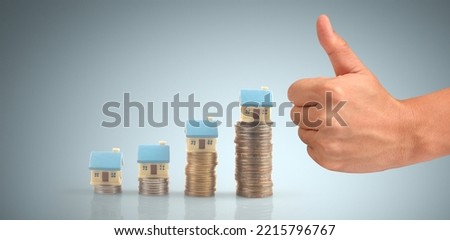 House Residential Structure in hand ,business home idea, model house and coin