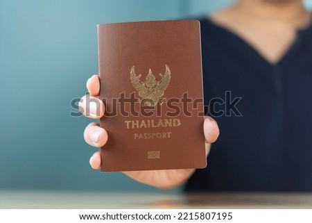 Man hand holding Thailand passport, travel concept.