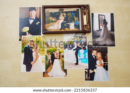 printed wedding photos and a wooden box with a flash drive. the concept of preserving the memory of an important event, the services of a professional photographer for the celebration.