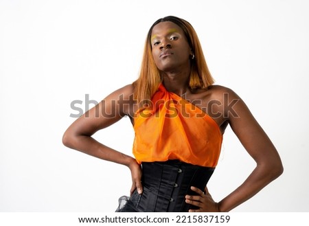 Black ethnic man in a studio, LGTBI concept, brave and empowered young man with wig