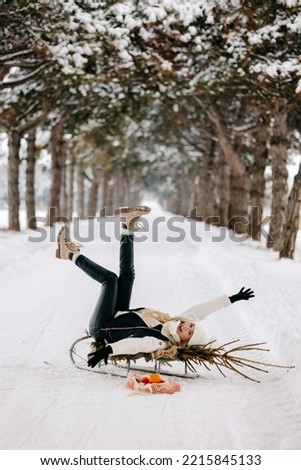 woman enjoys winter, happy woman on sled.
