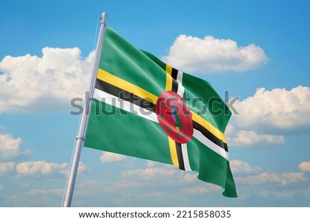 Dominica flag and blue sky with clouds.