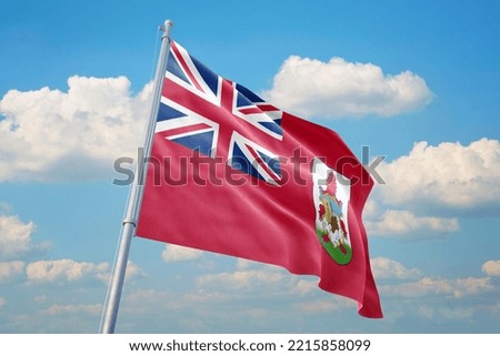 Bermuda flag and blue sky with clouds.