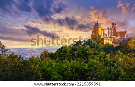 National Palace of Pena in Sintra, near Lisbon, Portugal. Picturesque landscape with dawn and green trees. Dramatic morning sky with clouds and sunlight. Royalty-Free Stock Photo #2215859591